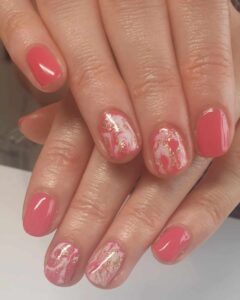 change is afoot - two hands overlapping showing a pink/peach marble effect nail polish