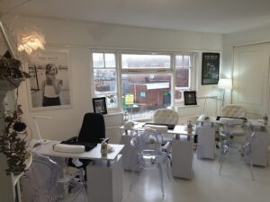 Change is afoot - nail divas beauty salon white table and chairs set up for treatments, black and white photos on the walls